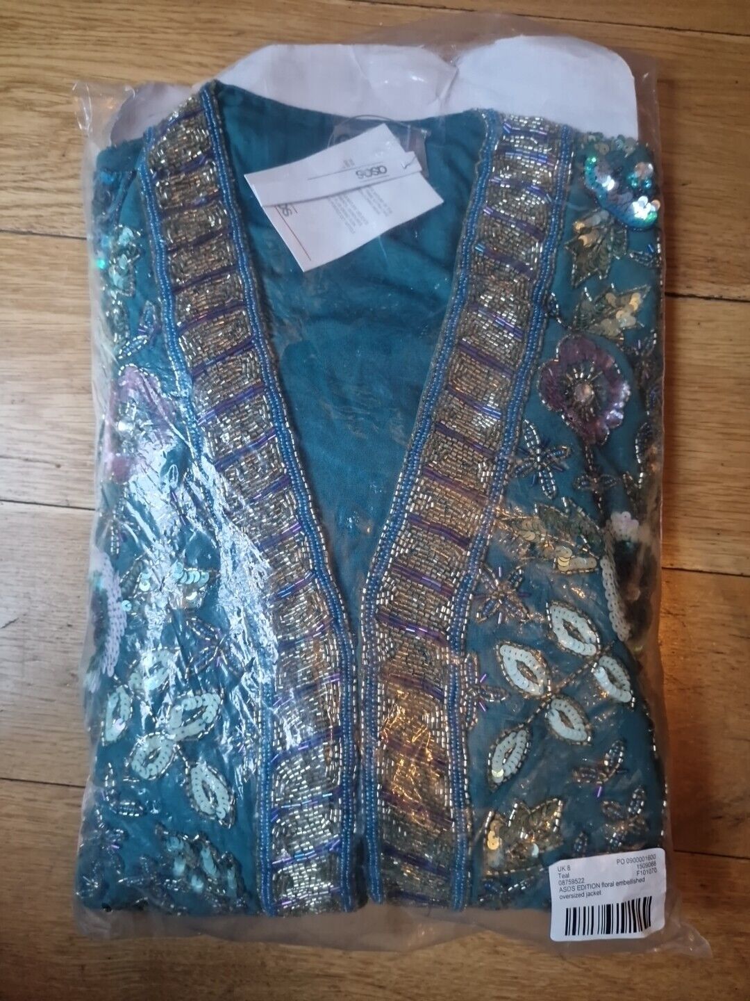 ASOS floral embellished oversized jacket in teal with intricate sequin and bead detailing folded in packaging