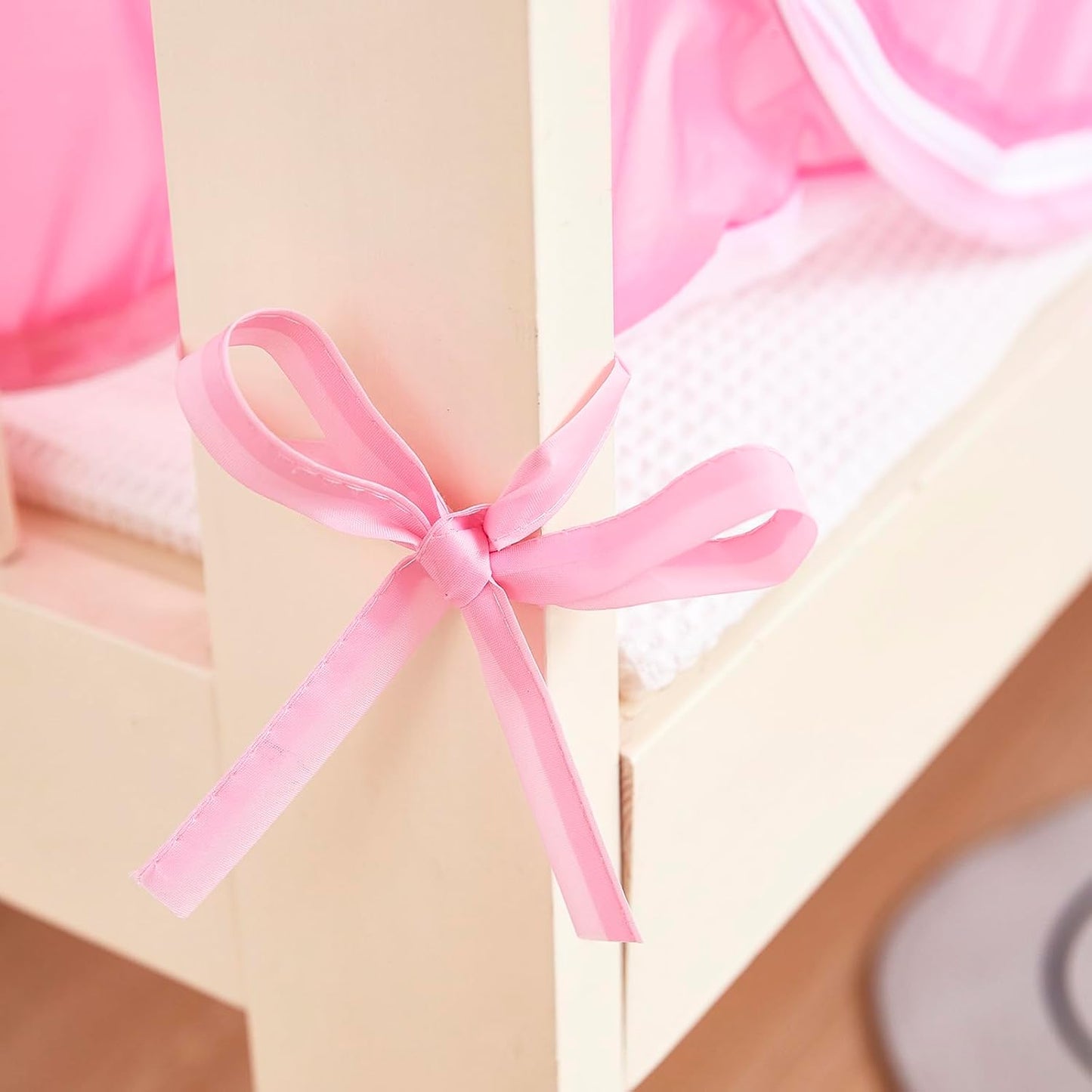 Pink ZIQINPSQ baby crib tent to stop climbing with a decorative bow on the side