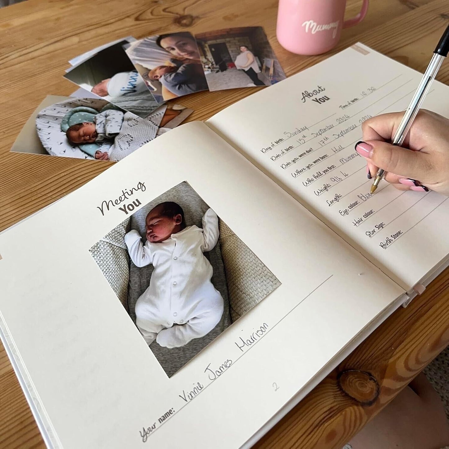 Gateway22 baby journal first steps open with handwritten notes and baby photos on wooden table