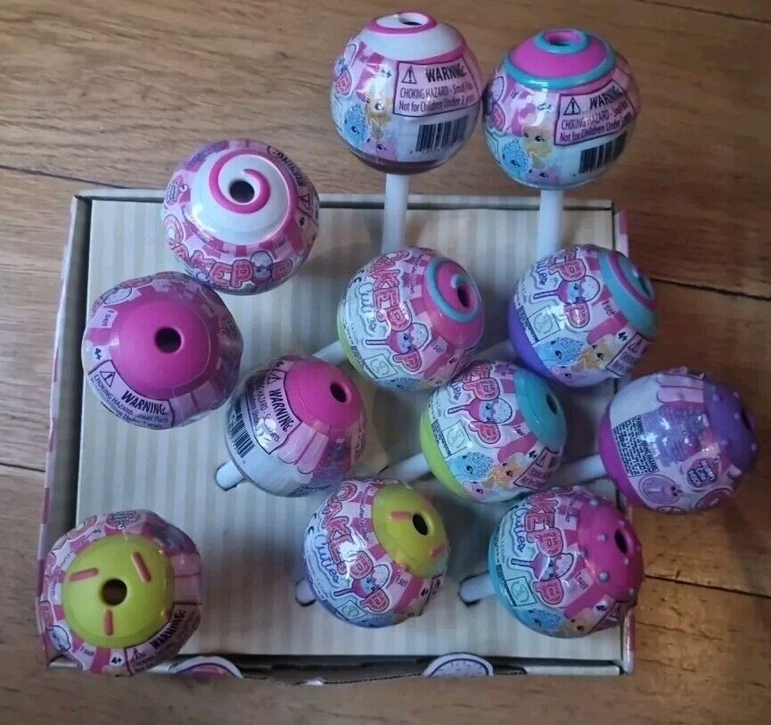 Assorted Cake Pop Cuties Surprise Toys displayed on a kraft paper background
