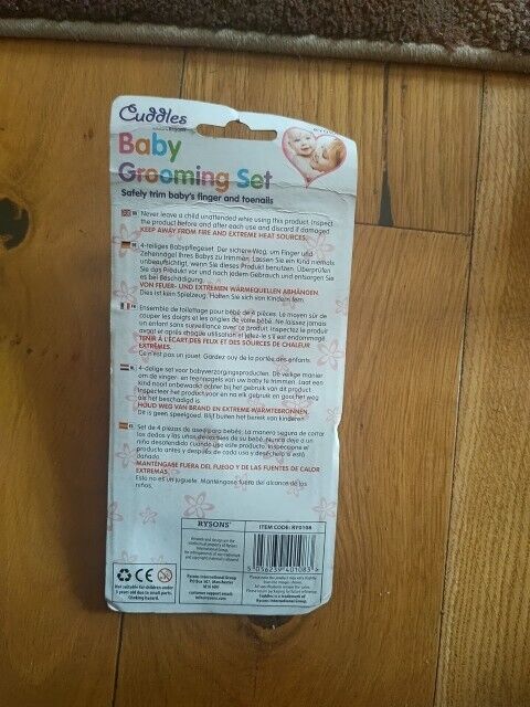 Cuddles baby grooming set packaging featuring safety instructions and product details for newborn care
