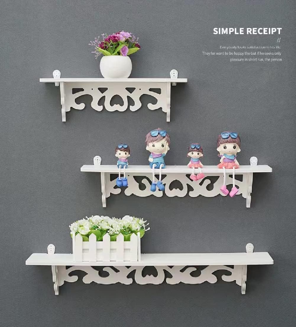 Decorative floating shelves set in white with playful characters and plants for stylish home display