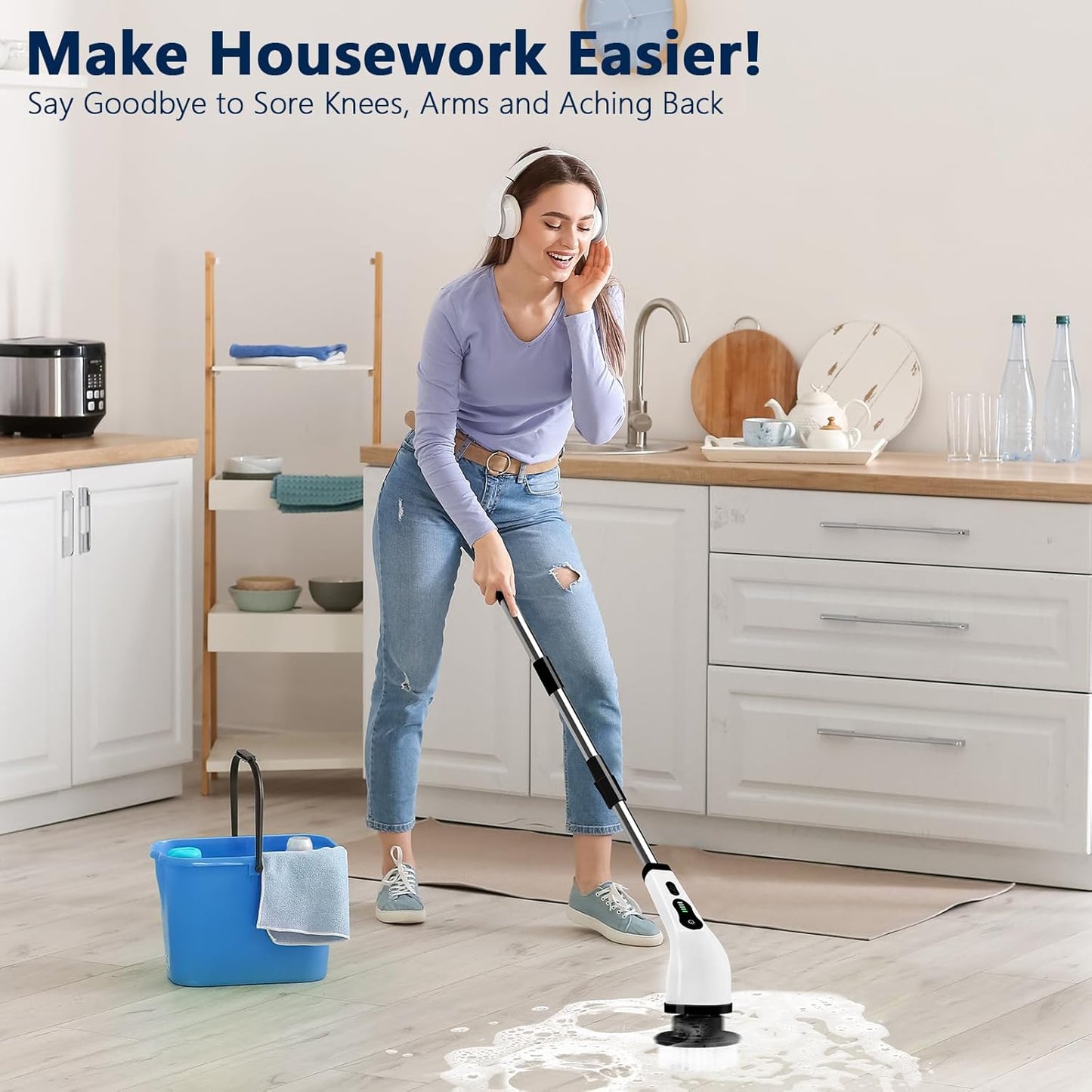 Woman using electric spin scrubber for bathroom to clean tiled floor in a modern kitchen