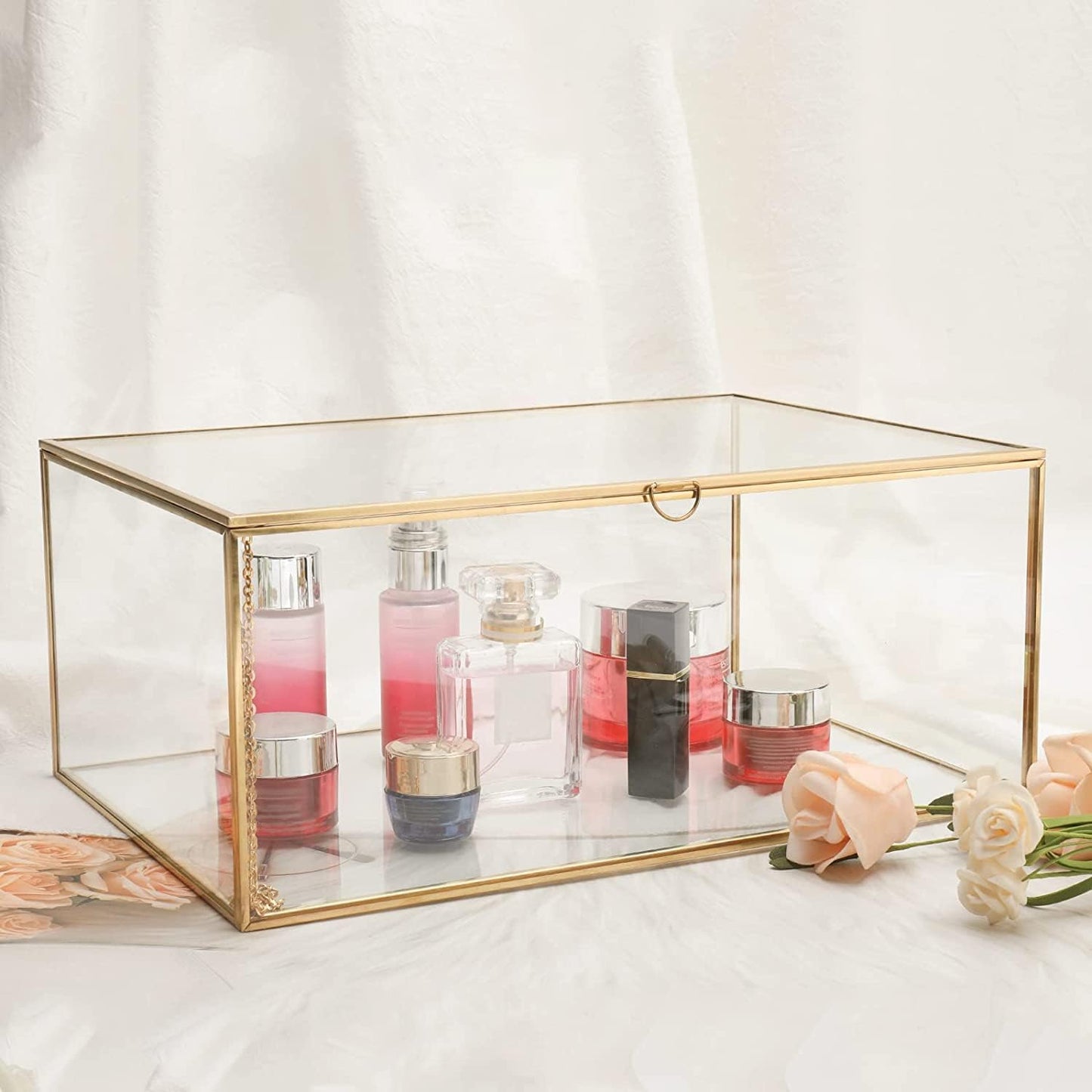 Gold glass terrarium box for elegant storage of perfumes and cosmetics on a chic vanity