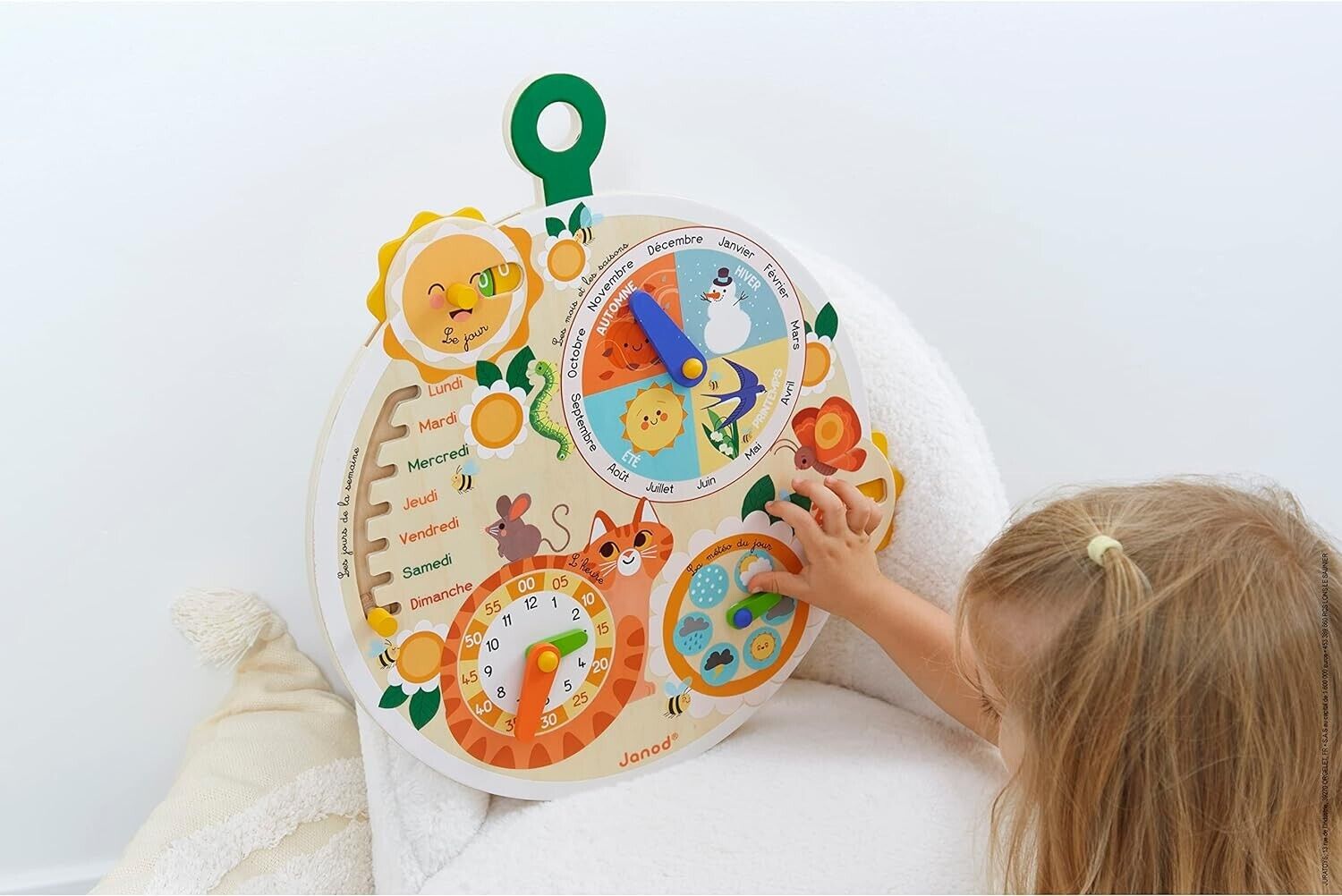 Child playing with Janod wooden time wheel educational game featuring colourful animals and interactive elements