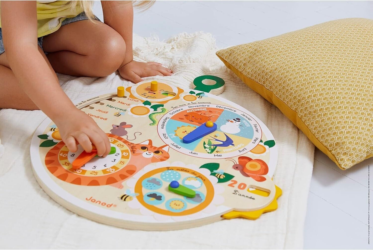 Child playing with Janod wooden time wheel educational game to learn time and numbers