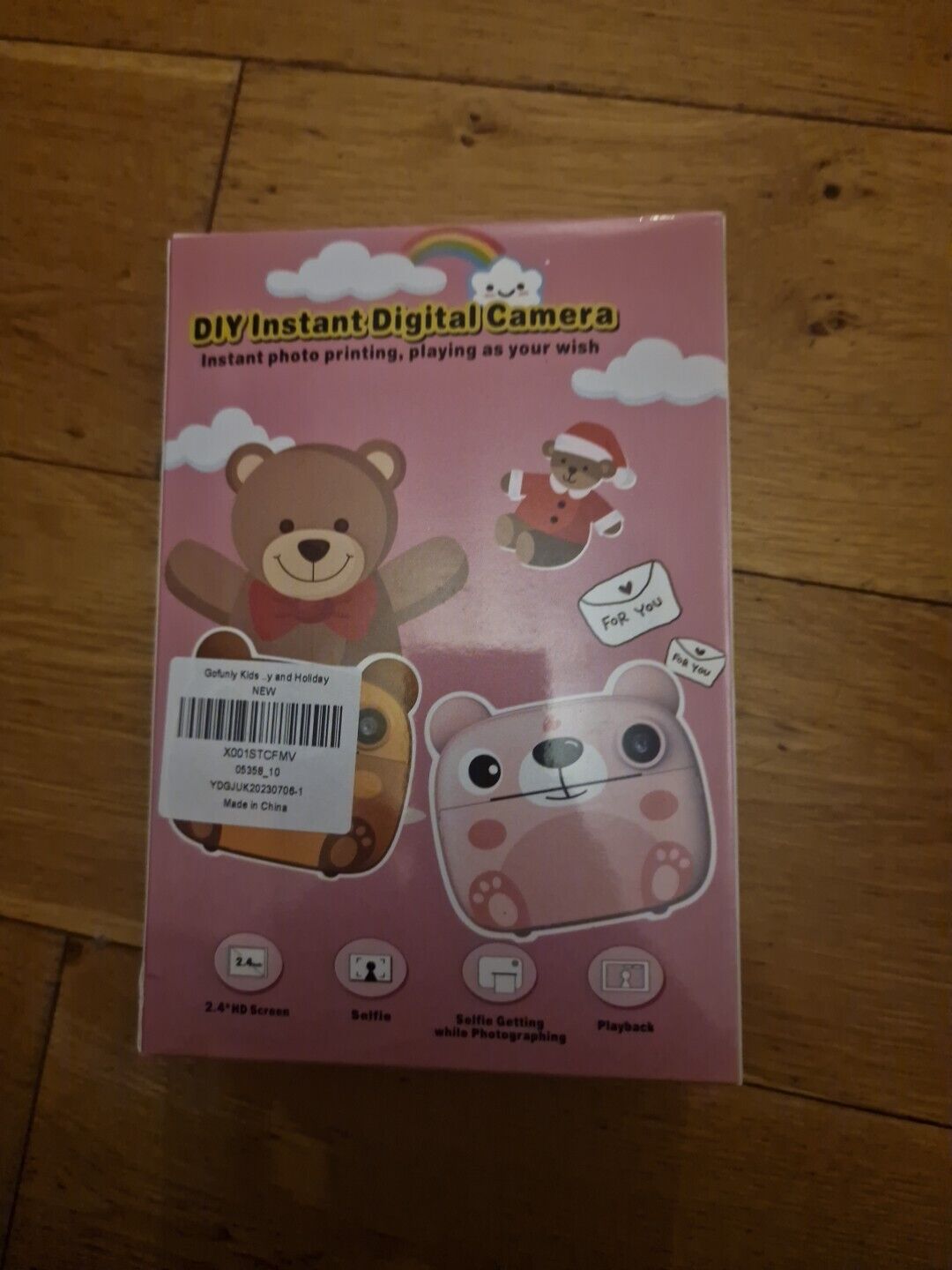 Kids instant digital camera box design featuring playful bear and Santa illustrations