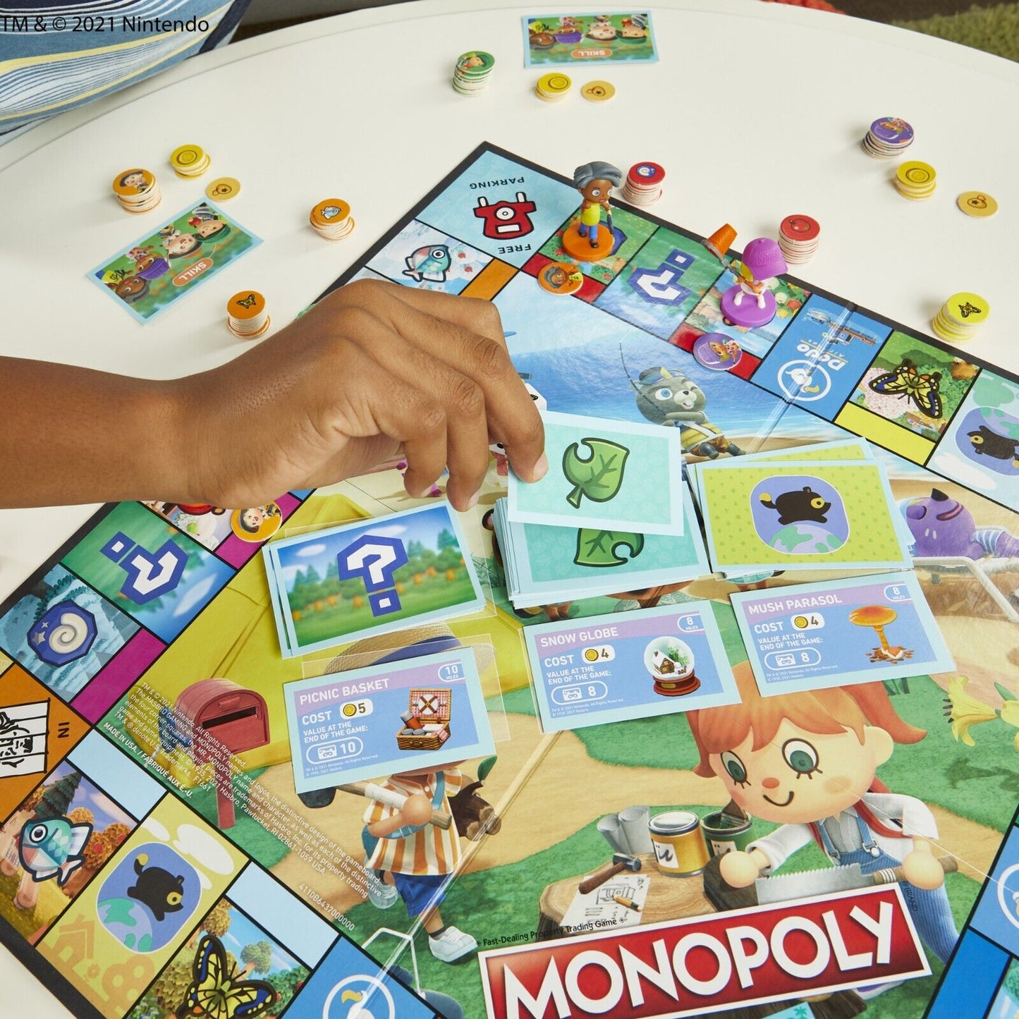 Monopoly Animal Crossing Board Game in action with player hand and colorful game pieces