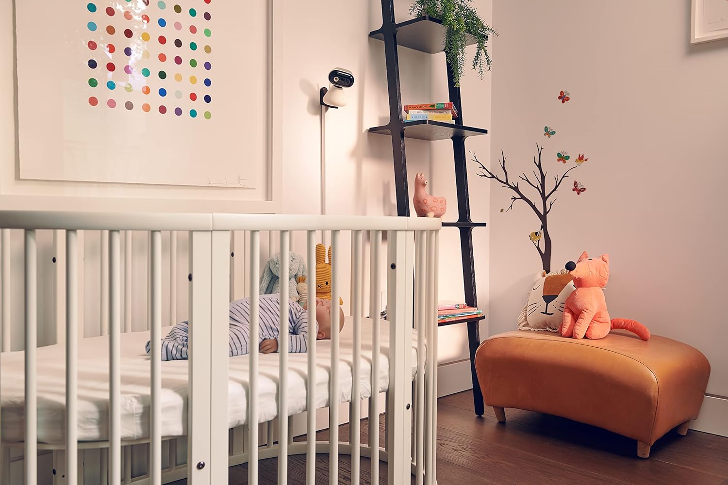 Motorola video baby monitor mounted in a modern nursery with a crib and decorative elements