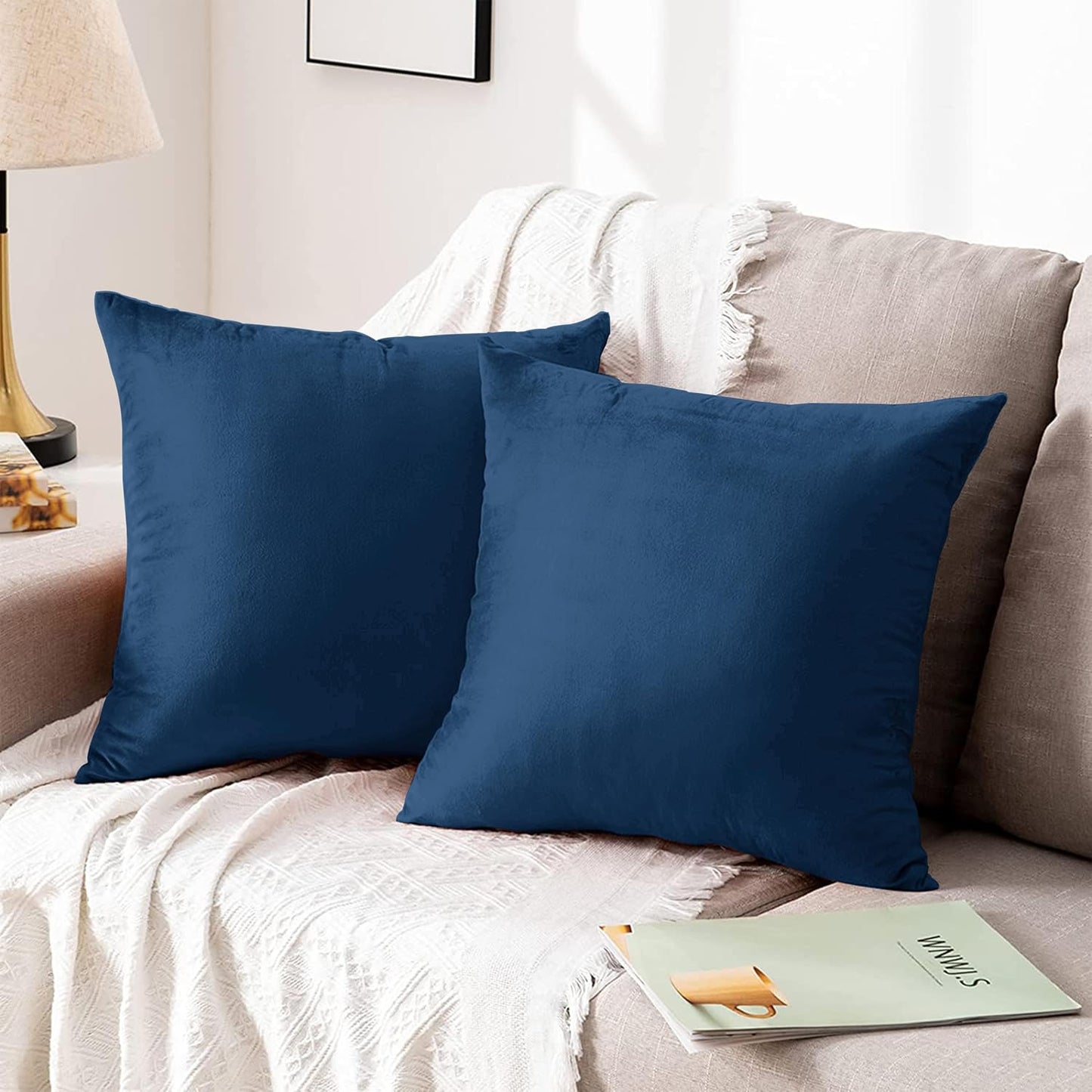 Navy crushed velvet cushion covers on a stylish couch for a modern home decor