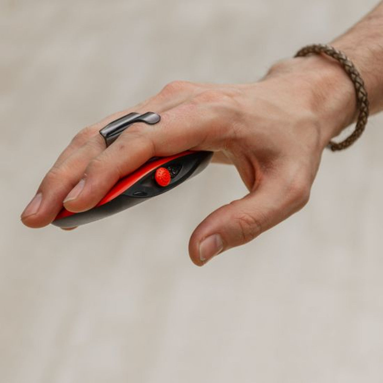 Hand holding the RED5 red motion control drone remote with ergonomic design for easy handling