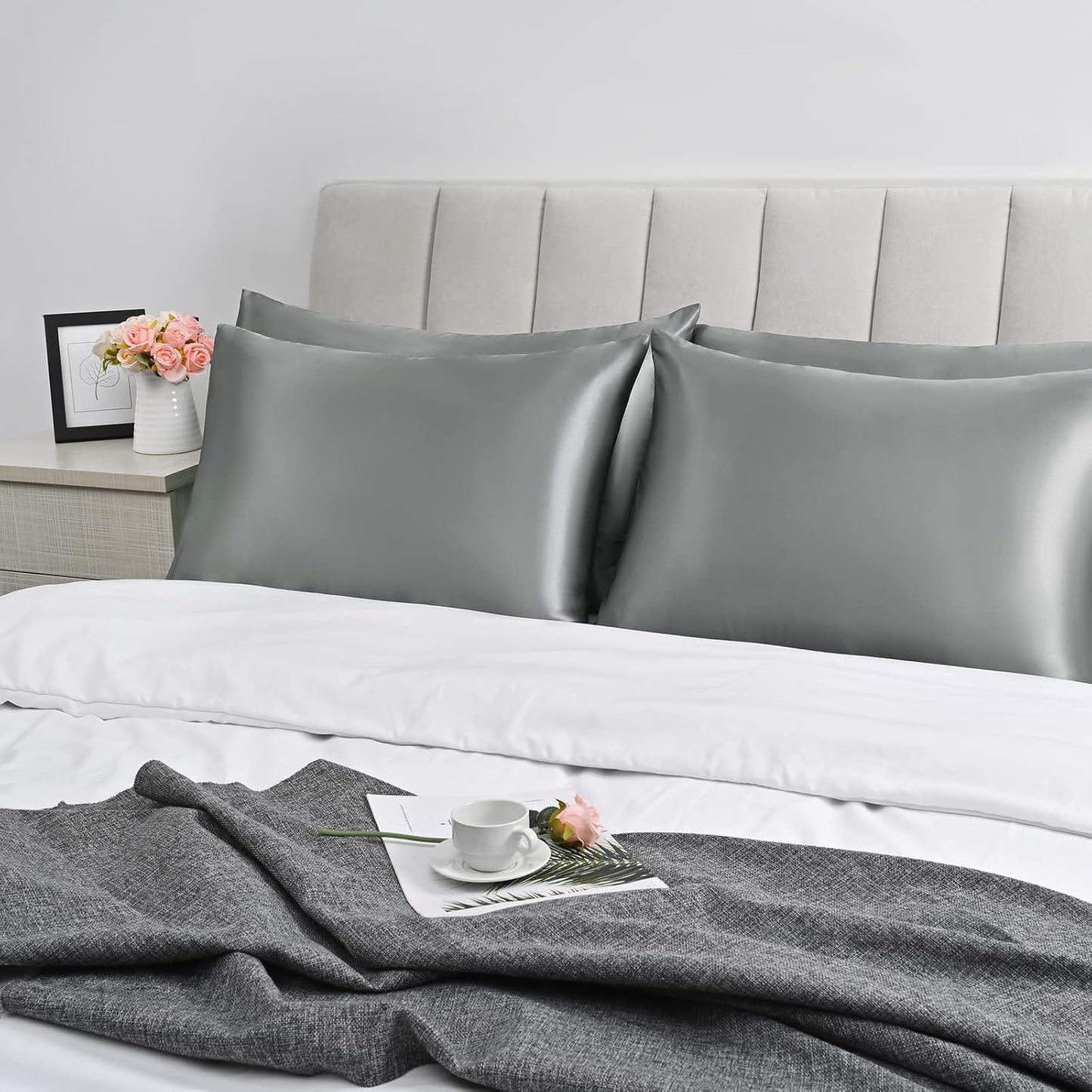 Bedcozy grey satin pillowcase for hair and skin on a neatly made bed with decorative accessories