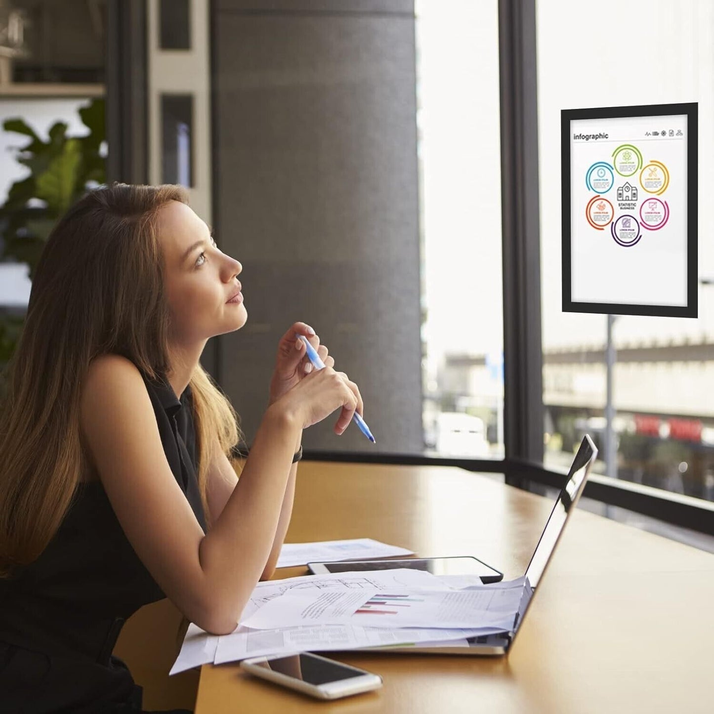 Self adhesive magnetic picture frame A3 displayed on a window, showcasing infographics in a modern office setting