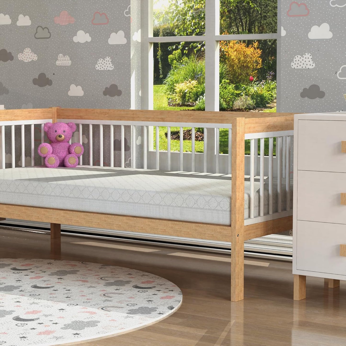 Sleepy Owl premium foam cot mattress placed in a stylish nursery with wooden crib and soft decor