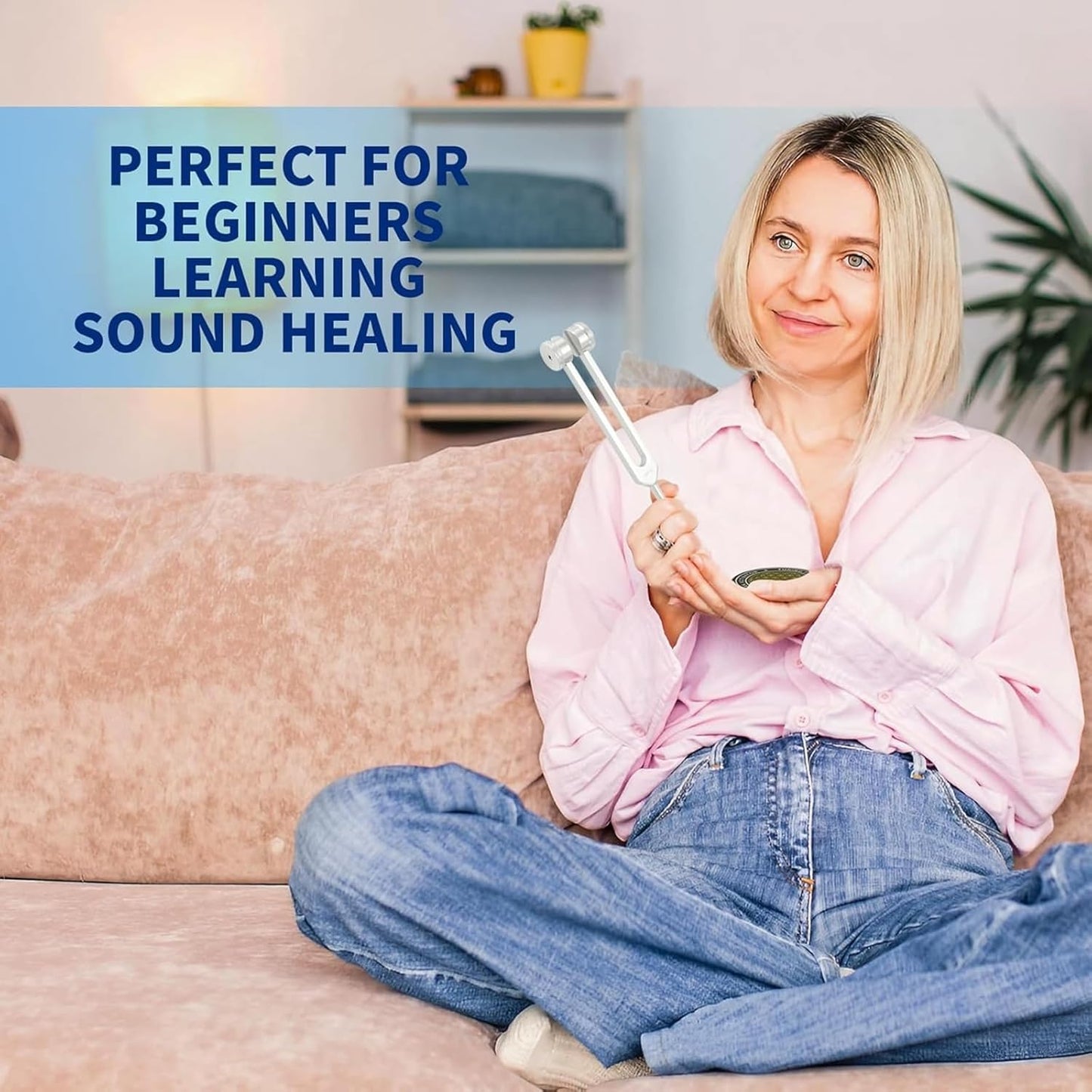 Woman sitting on a sofa holding tuning forks for healing, ideal for beginners in sound healing