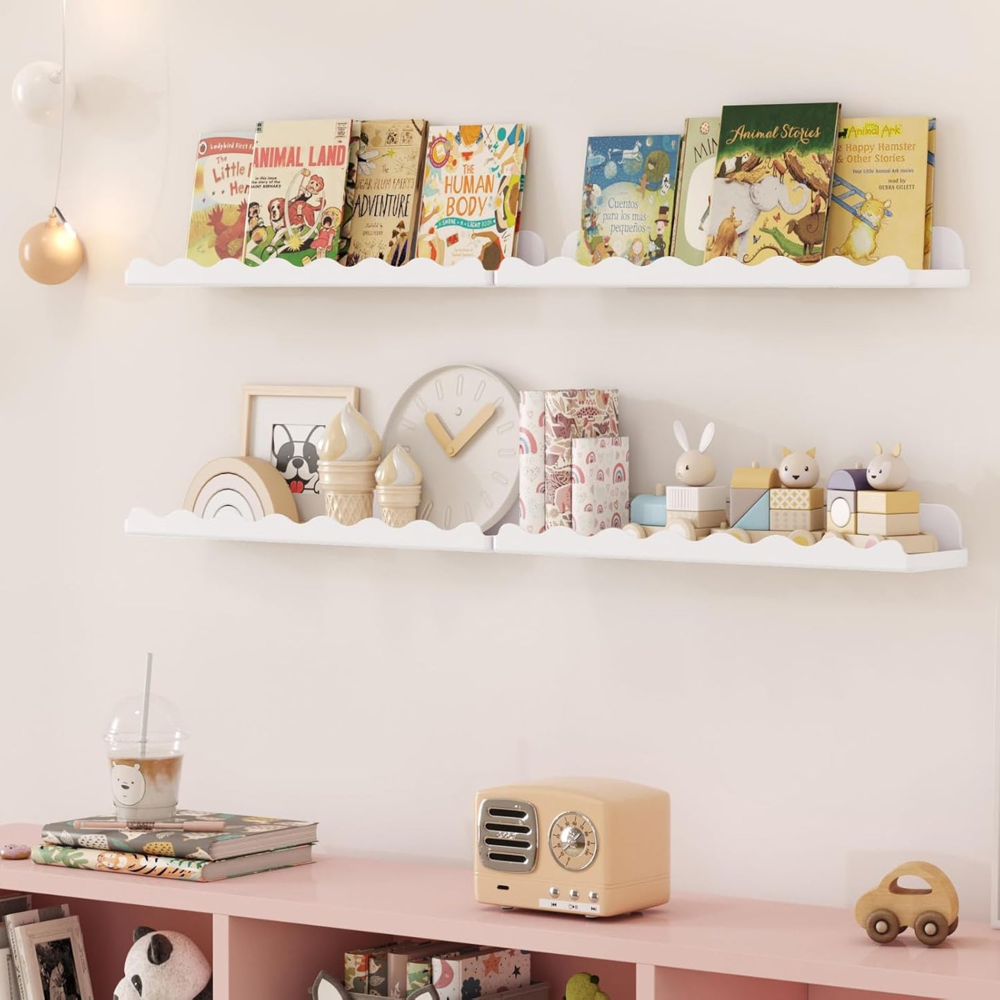 Stylish white cloud floating wall shelves displaying children's books and cute decor in a nursery