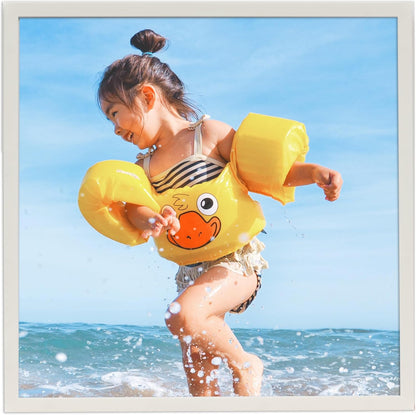 8x8 white photo frame showcasing a cheerful child playing at the beach with a yellow duck inflatable