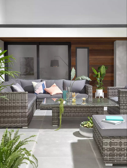 Aruba 6 seater corner cushion set in grey rattan with a glass coffee table and vibrant decor