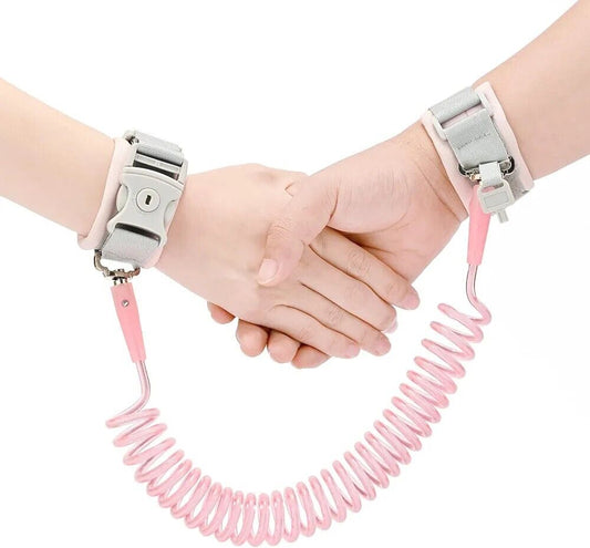 Anti lost toddler wrist strap with lock in pink, designed for child safety during outdoor activities