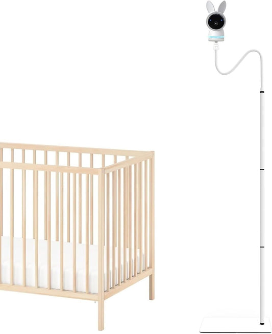 The Trading Warehouse baby monitor floor stand next to a wooden crib for easy monitoring