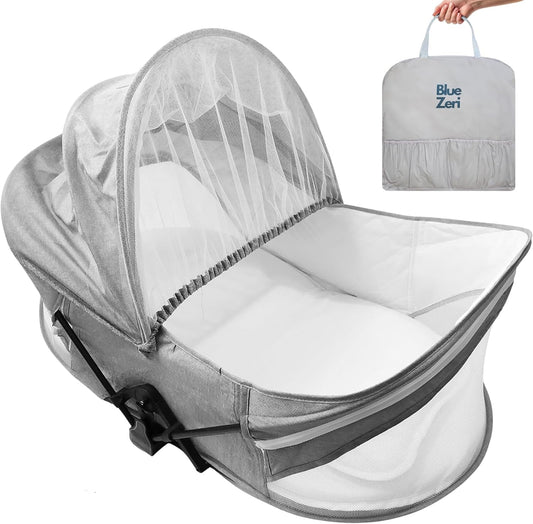 Blue Zeri portable baby travel bassinet with mosquito net and carry bag for easy transport