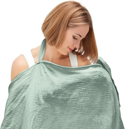Light green breathable muslin nursing cover draped over a woman for comfortable breastfeeding