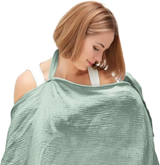 Light green breathable muslin nursing cover draped over a woman for comfortable breastfeeding