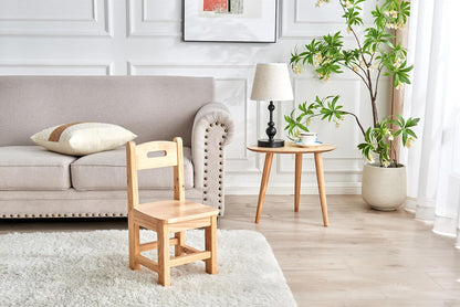 Children's wooden chair and stool set in a cosy living room with a sofa and decorative plants