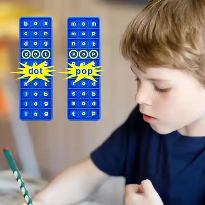 Child playing with CVC phonics word game for kids featuring cards with words dot and pop