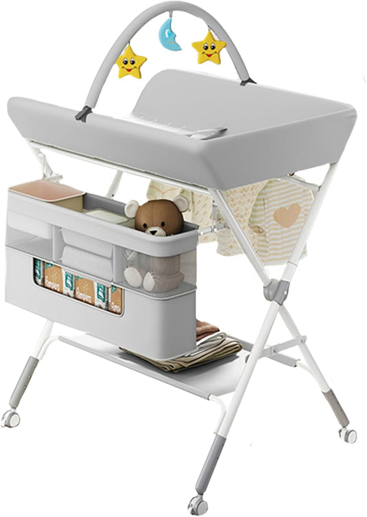 Yosamy foldable baby changing table in grey with storage pockets and hanging toys for convenient diaper changes