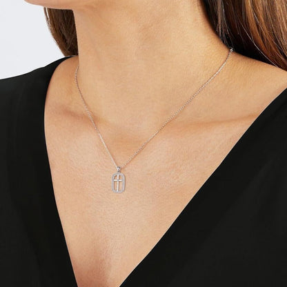 Sterling silver cross necklace for women displayed on a model's neck, featuring a delicate design