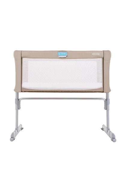 GRACO bedside crib for newborns with mesh sides and a sturdy frame for safe sleeping