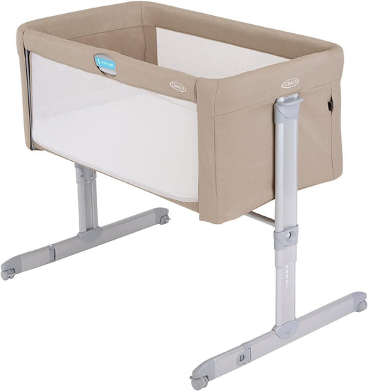GRACO bedside crib for newborns in a neutral colour with adjustable height and mesh sides