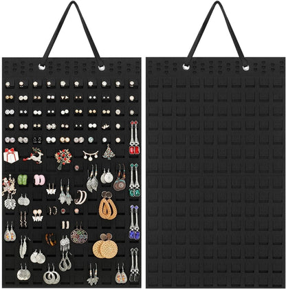 Hanging earrings holder in black fabric displaying various earrings for organised storage