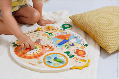 Child playing with Janod wooden time wheel educational game to learn time and numbers
