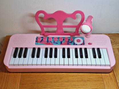 Fascinating pink kids piano keyboard with microphone for interactive musical play