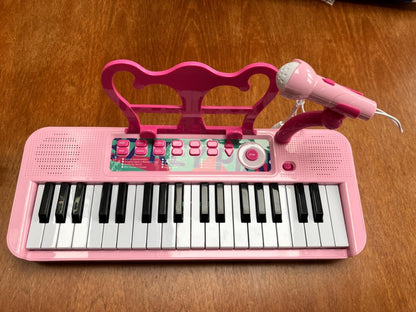 Fascinating kids piano keyboard with microphone in pink, designed for interactive musical fun