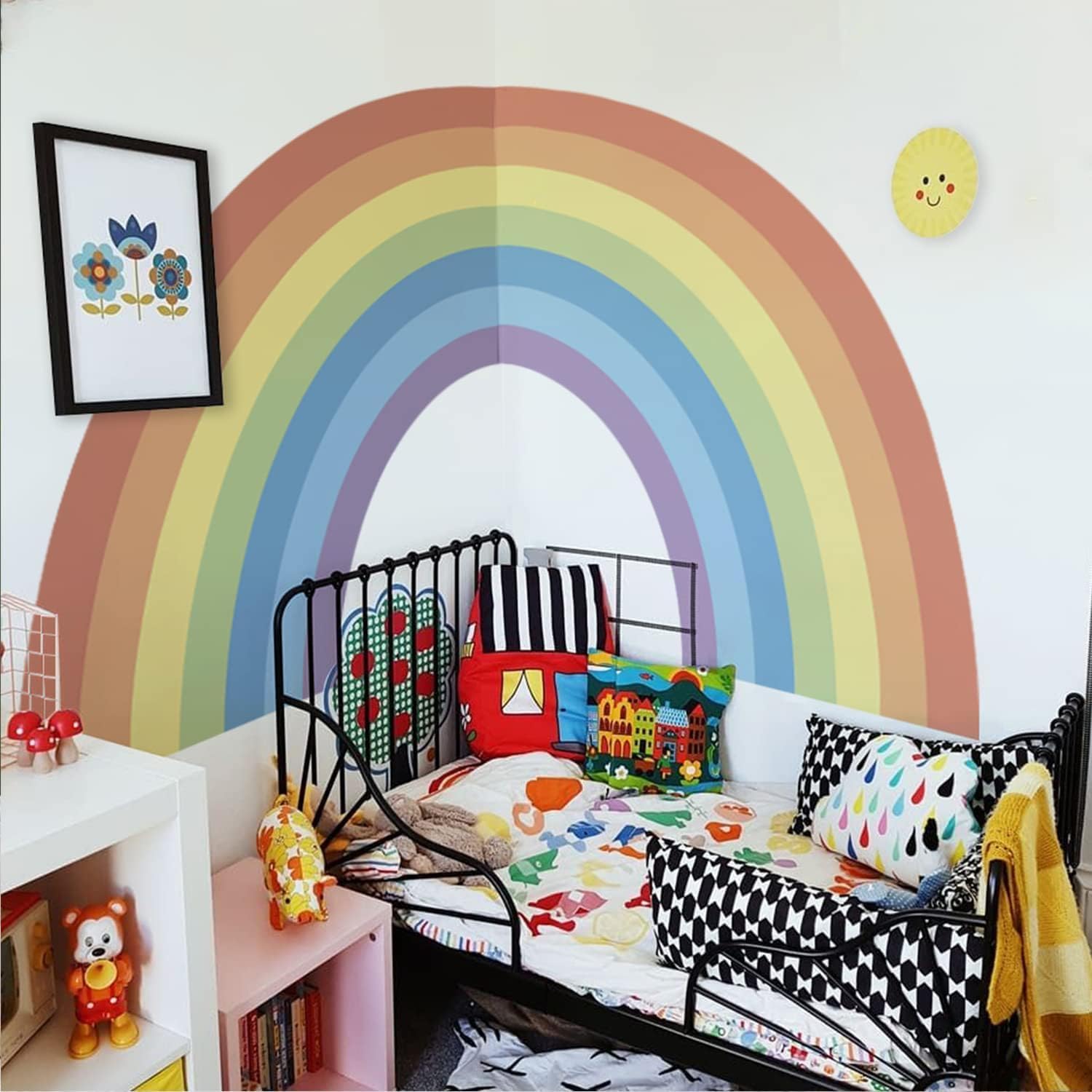 Large pastel rainbow wall stickers in a bright children's bedroom with colourful decor