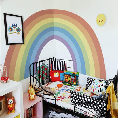 Large pastel rainbow wall stickers in a bright children's bedroom with colourful decor