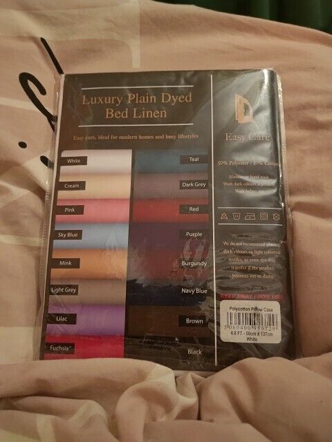 Pack of polycotton pillow cases in various colours including teal, pink, and grey for luxury bed linen
