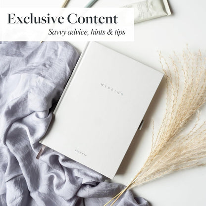 Luxury wedding planner set by Scribble & Dot on soft fabric with dried flowers