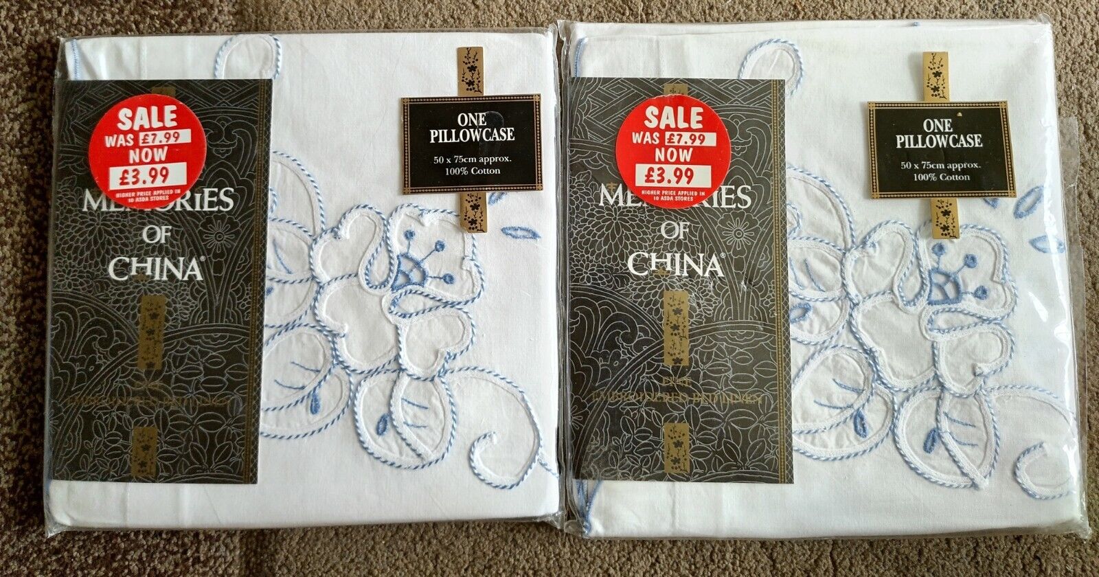 Memories of China pillowcases featuring floral embroidery in blue on soft white fabric