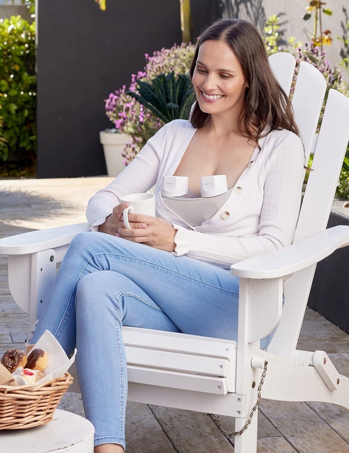 Momcozy S12 Pro wearable breast pump worn by a mother relaxing in a garden chair