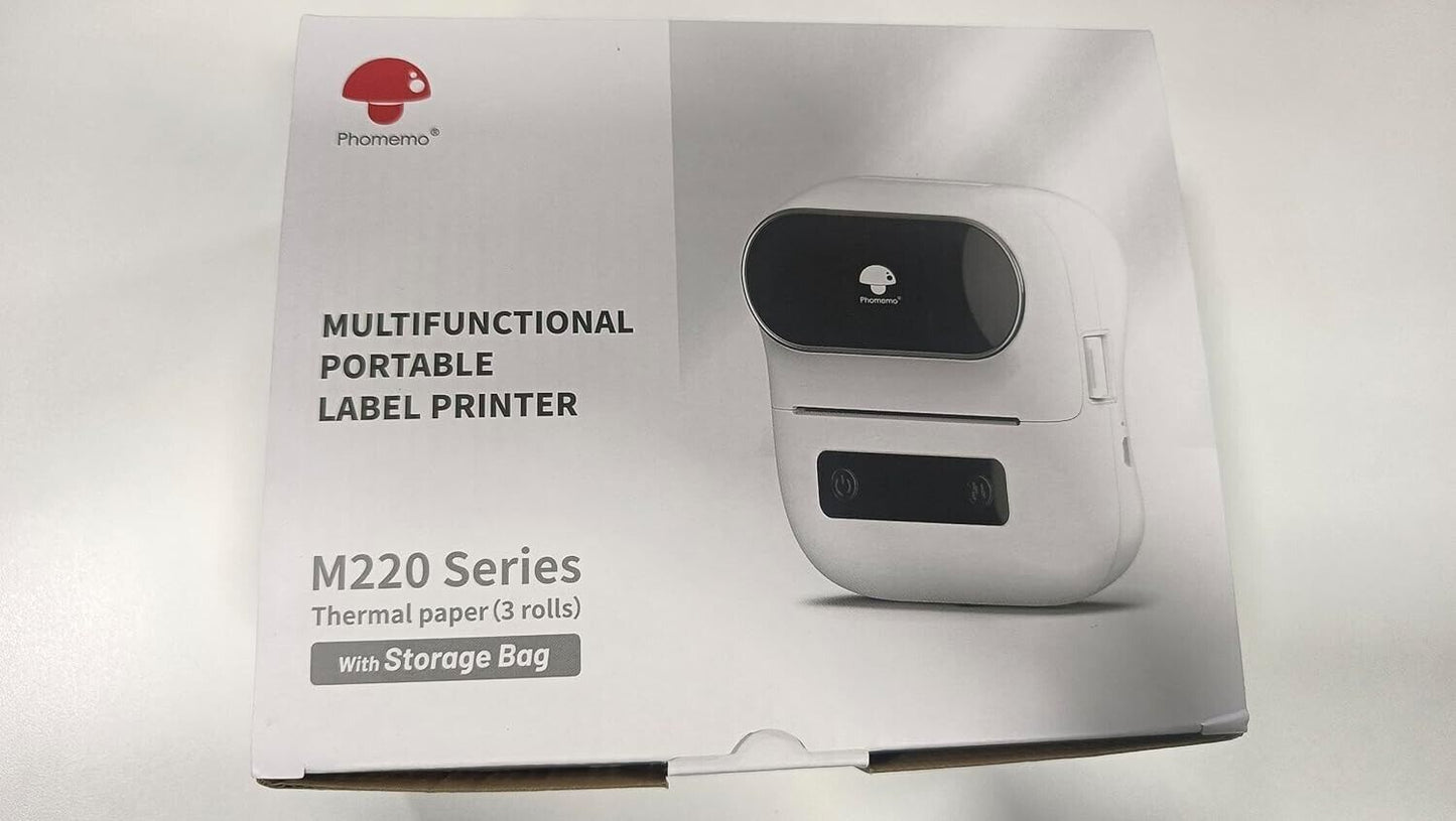 Phomemo M220 portable barcode printer in box with storage bag and thermal paper rolls included
