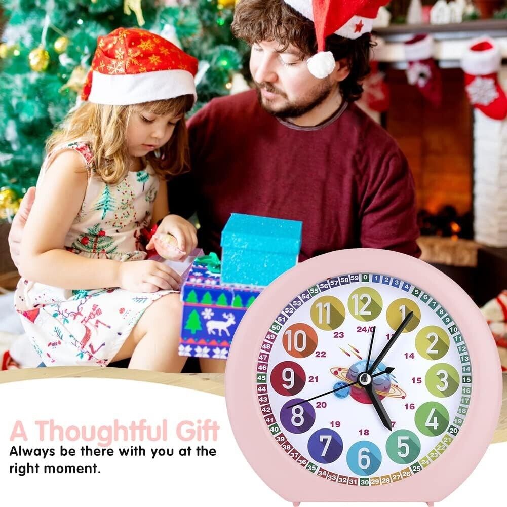 Pink alarm clock with colourful numbers and black hands next to a child and parent by a Christmas tree