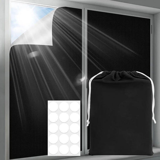 Portable blackout blind with adhesive attachment for easy installation and a drawstring storage bag