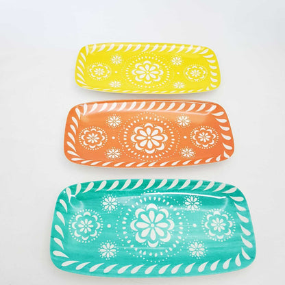 Set of three vibrant floral serving trays in yellow, orange, and turquoise from The Trading Warehouse