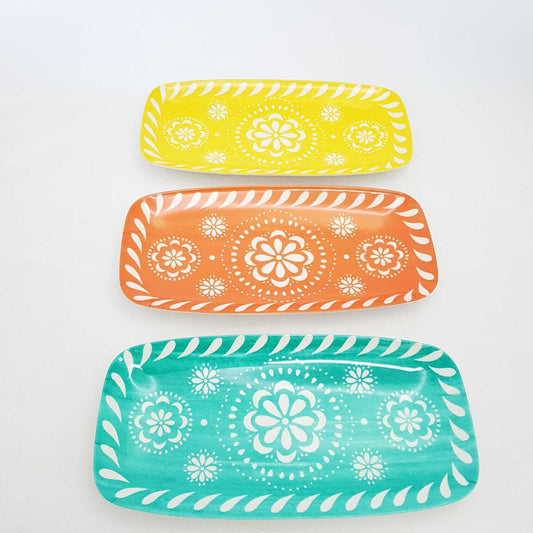 Set of three vibrant floral serving trays in yellow, orange, and turquoise from The Trading Warehouse