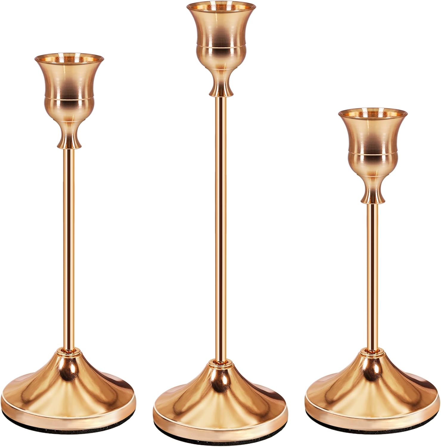 Set of three elegant rose gold candle holders with varying heights for stylish home decor