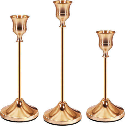 Set of three elegant rose gold candle holders with varying heights for stylish home decor